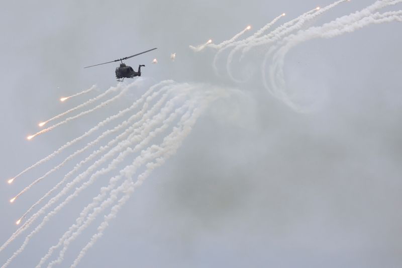 &copy; Reuters. FILE PHOTO: An AH-1 Cobra helicopter fires during the live-fire, anti-landing Han Kuang military exercise, which simulates an enemy invasion, in Taichung