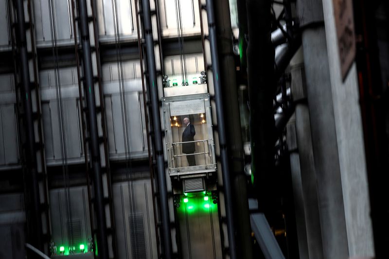 &copy; Reuters. FILE PHOTO: A man takes a elevator in the Lloyds of London building in the financial district in London