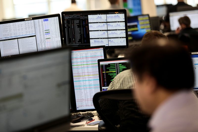 &copy; Reuters. Traders looks at financial information on computer screens on the IG Index trading floor