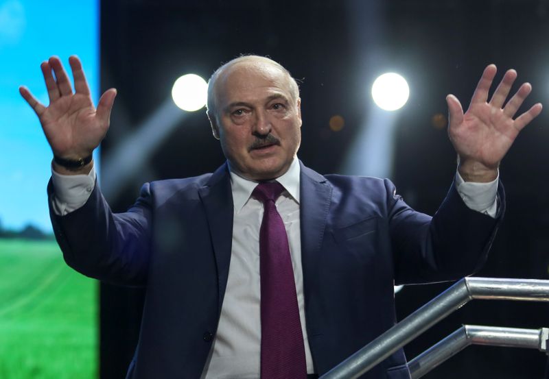 &copy; Reuters. Belarusian President Alexander Lukashenko waves to his supporters at the forum of Union of Women in Minsk