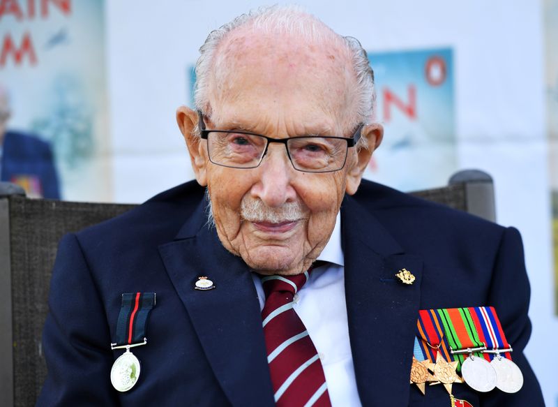 &copy; Reuters. FILE PHOTO: Captain Sir Tom Moore smiles as he launches his autobiography book at his home in Milton Keynes