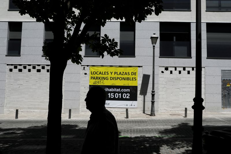 © Reuters. FILE PHOTO: A man walks past a sign that reads 