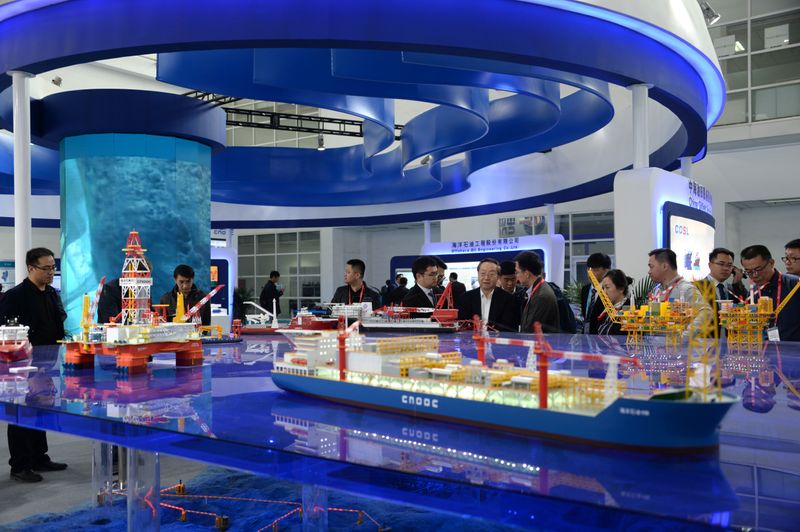 &copy; Reuters. FILE PHOTO: Models of ships and offshore oil drilling equipment of China National Offshore Oil Co (CNOOC) are displayed in Beijing