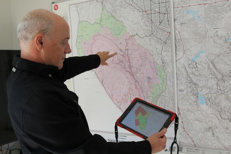 &copy; Reuters. Zonehaven CEO and founder Charlie Crocker shows the how the platform assists with evacuation management using a map of the recent CZU fire at his home in San Francisco