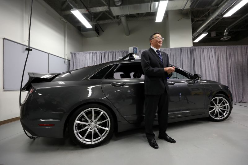 &copy; Reuters. Blackberry CEO Chen stands in front of an autonomous vehicle at the BlackBerry QNX headquarters in Ottawa
