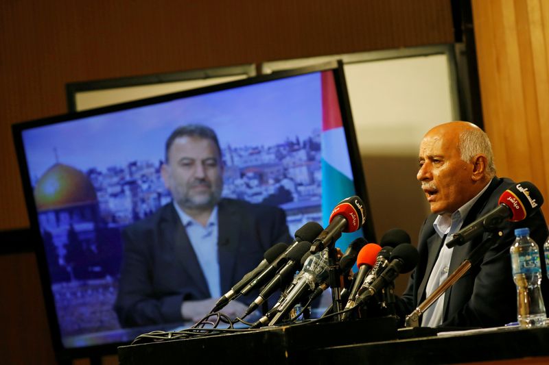 &copy; Reuters. FILE PHOTO: Senior Fatah official Jibril Rajoub speaks as deputy Hamas chief Saleh Arouri appears on a television screen during a video conference to discuss Israel&apos;s plan to annex parts of the Israeli-occupied West Bank