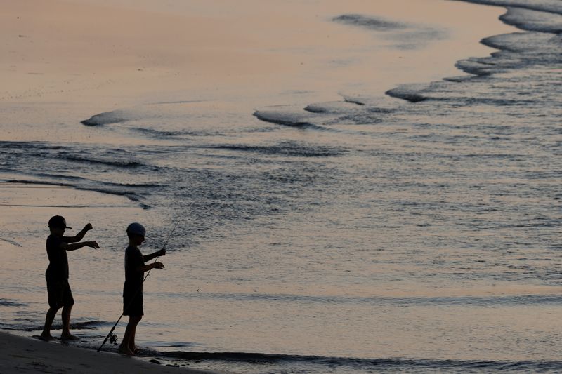 &copy; Reuters. Two boys fish at Cardiff State Beach