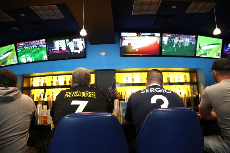 &copy; Reuters. FILE PHOTO: Gamblers watch sports on televisions at Monmouth Park Sports Book by William Hill, shortly after the opening of the first day of legal betting on sports in Oceanport