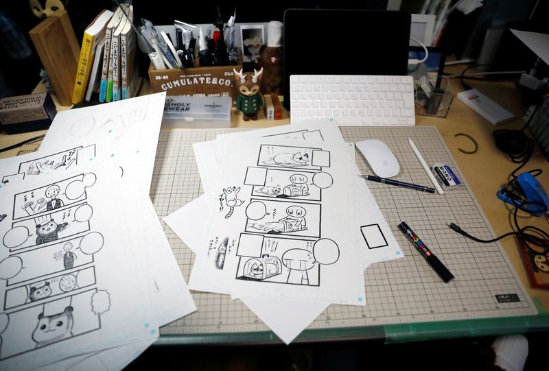 &copy; Reuters. FILE PHOTO: Sheets with four-panel strip comic &apos;Koguma&apos;s Cake Shop&apos; are seen at his workspace in Tokyo