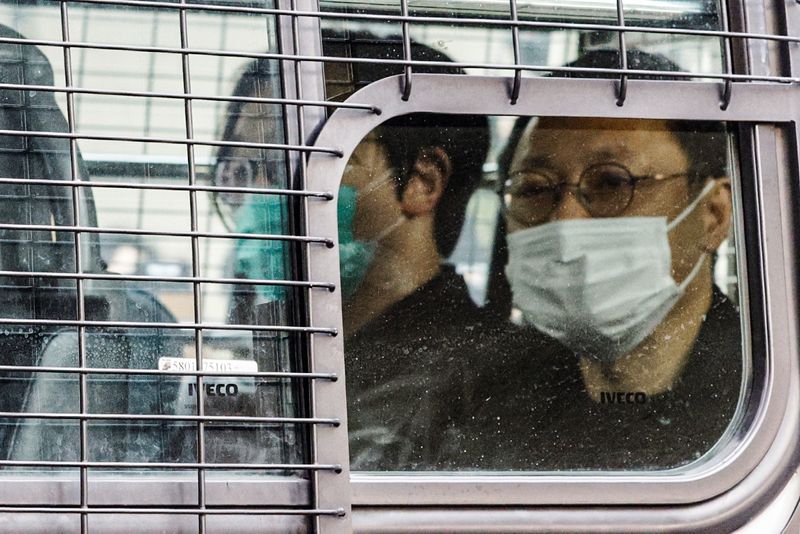 &copy; Reuters. Pro-democracy activist Benny Tai and Mike Lam King-Nam arrives at West Kowloon Magistrates&apos; Courts in a police van for a hearing over the national security law charges in Hong Kong
