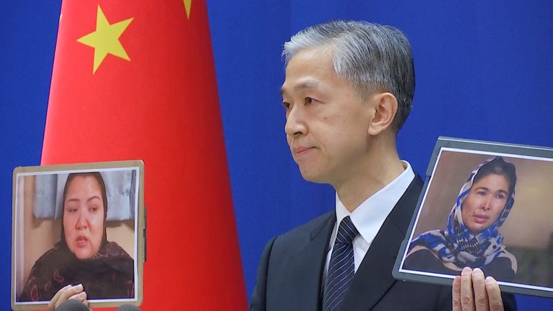 &copy; Reuters. Chinese Foreign Ministry spokesman Wang Wenbin holds pictures while speaking during a news conference in Beijing