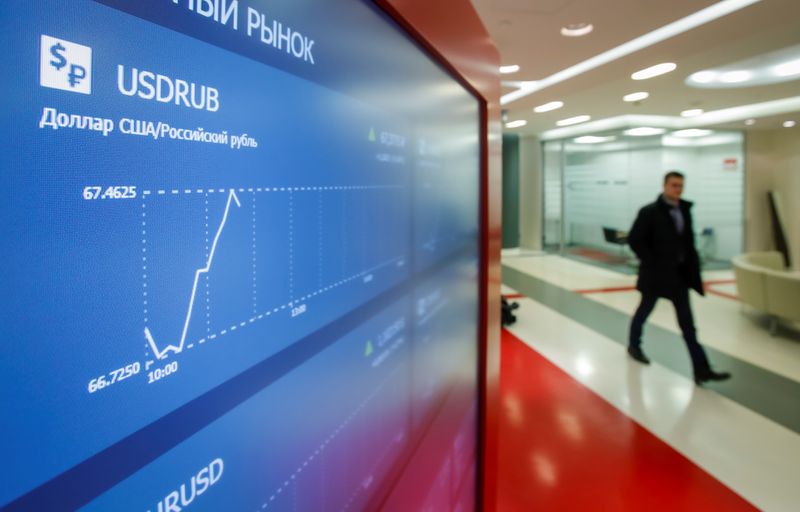 &copy; Reuters. A man walks past an information screen inside the office of the Moscow Exchange in Moscow