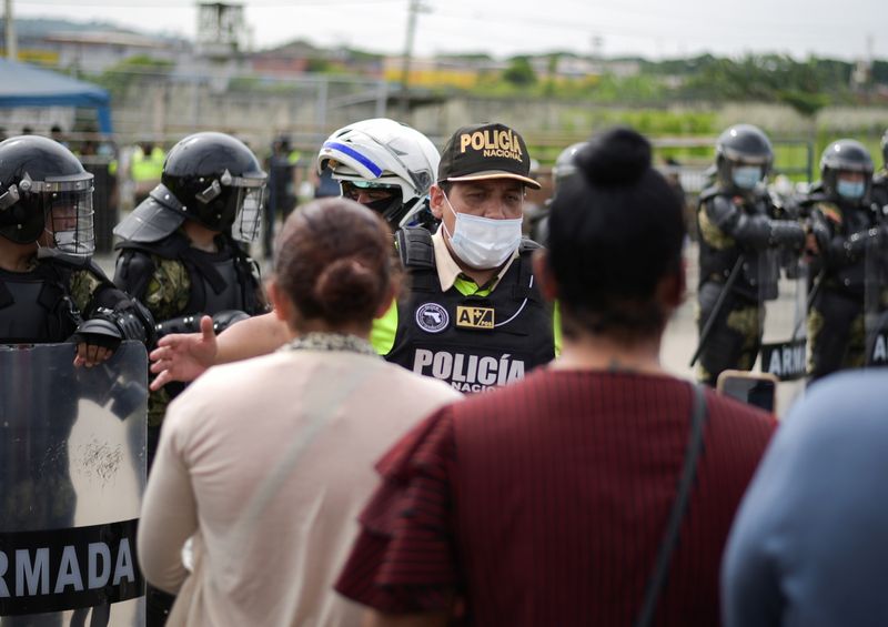 &copy; Reuters. FOTO DE ARCHIVO: Familiares de reclusos argumentan que un oficial de policía afuera de una prisión donde los reclusos fueron asesinados durante un motín que el gobierno describió como una acción concertada de organizaciones criminales, en Guayaquil, 