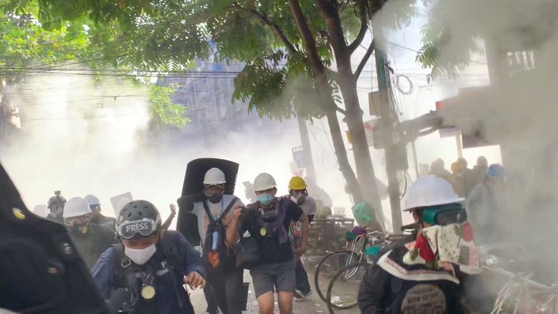 &copy; Reuters. Video grab of protesters setting off smoke grenades to block the view from snipers in Sanchaung, Yangon, Myanmar