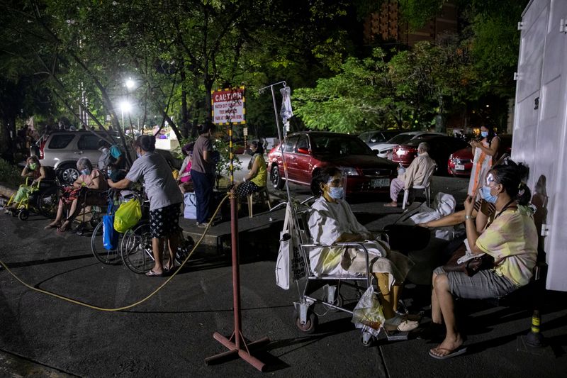 &copy; Reuters. Patients at Philippine General Hospital are evacuated after a fire broke past midnight in the government-run facility amid the coronavirus disease (COVID-19) outbreak in Manila, Philippines, May 16, 2021. REUTERS/Eloisa Lopez