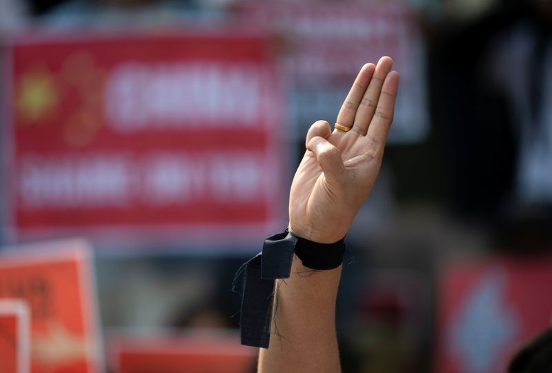 &copy; Reuters. FILE PHOTO: A demonstrator shows the three-finger salute during a protest against the military coup in Yangon, Myanmar, February 21, 2021. REUTERS/Stringer
