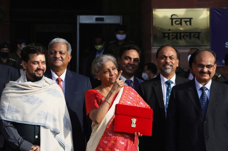 &copy; Reuters. FILE PHOTO: India's Finance Minister Nirmala Sitharaman stands next to Minister of State for Finance and Corporate Affairs Anurag Thakur (L) as she leaves her office to present the federal budget in the parliament in New Delhi, India, February 1, 2021. RE