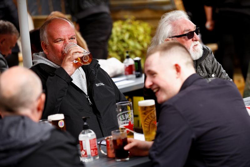 &copy; Reuters. Customers at The Swinging Witch pub enjoy drinks, as lockdown eases amid the coronavirus disease (COVID-19) pandemic, in Northwich, Cheshire, Britain, May 15, 2021. REUTERS/Jason Cairnduff
