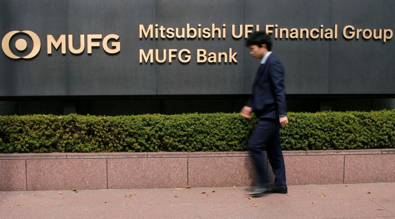 &copy; Reuters. FILE PHOTO: A man walks past a signboard of Mitsubishi UFJ Financial Group and MUFG Bank at its headquarters in Tokyo, Japan April 3, 2018. REUTERS/Toru Hanai