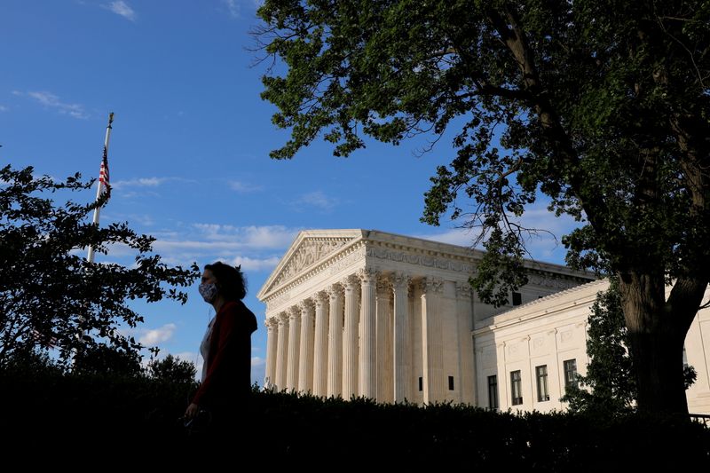 &copy; Reuters. FILE PHOTO: A person in a mask walks past the United States Supreme Court Building in Washington, D.C., U.S., May 13, 2021. REUTERS/Andrew Kelly