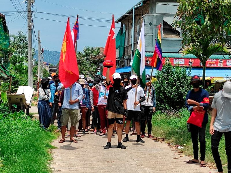 &copy; Reuters. FILE PHOTO: Demonstrators carry flags as they march to protest against the military coup, in Dawei, Myanmar April 27, 2021. Courtesy of Dawei Watch/via REUTERS   