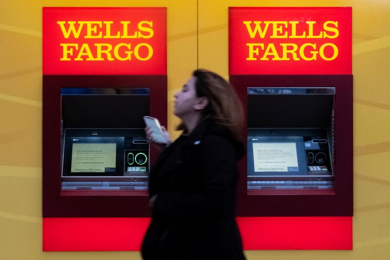 &copy; Reuters. FILE PHOTO: A woman walks past Wells Fargo bank in New York City, U.S., March 17, 2020. REUTERS/Jeenah Moon/File Photo