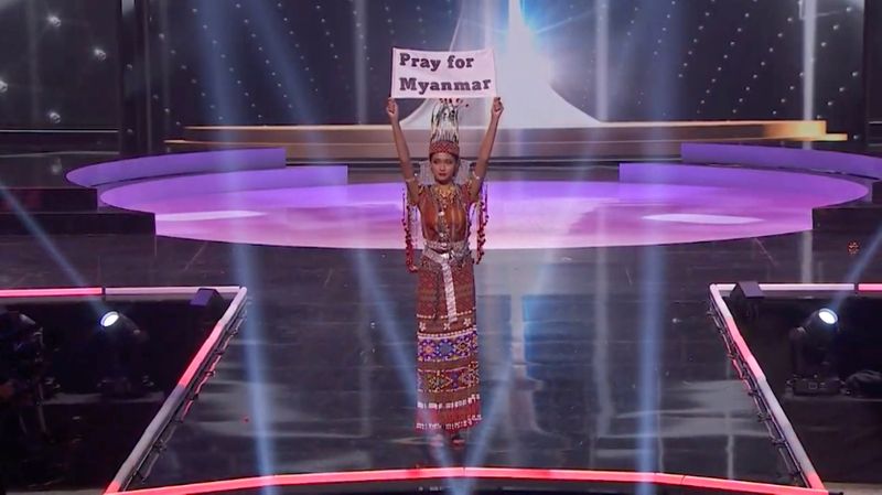 &copy; Reuters. Ma Thuzar Wint Lwin, Miss Universe Myanmar, holds up the "Pray for Myanmar" sign during Miss Universe pageant's national costume show, in Hollywood, Florida, U.S., May 13, 2021 in this screengrab taken from a handout video.   Courtesy MISS UNIVERSE/Handou