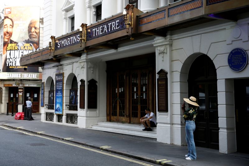 &copy; Reuters. FILE PHOTO: People stand next to St Martin's Theatre at London's West End in London, Britain, August 13, 2020. REUTERS/Henry Nicholls