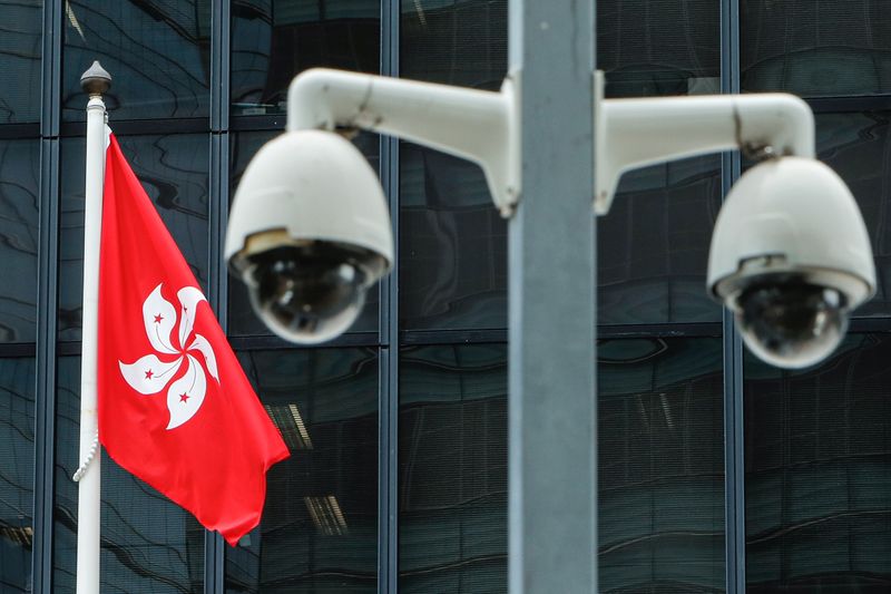 &copy; Reuters. FILE PHOTO: A Hong Kong flag is flown behind a pair of surveillance cameras outside the Central Government Offices in Hong Kong, China July 20, 2020. REUTERS/Tyrone Siu