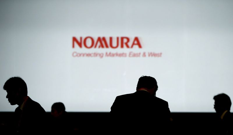 &copy; Reuters. FILE PHOTO: Investors stand in front of a screen showing the logo of Nomura Holdings in Tokyo, Japan, in this December 1, 2015 file photo.REUTERS/Toru Hanai