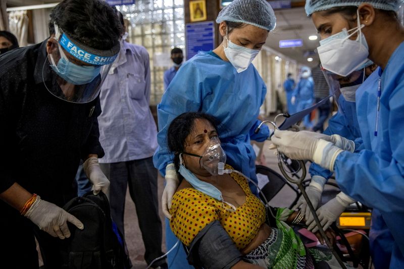 &copy; Reuters. FILE PHOTO: A patient suffering from the coronavirus receives treatment inside the emergency ward at Holy Family hospital in New Delhi, April 29. REUTERS/Danish Siddiqui/File Photo