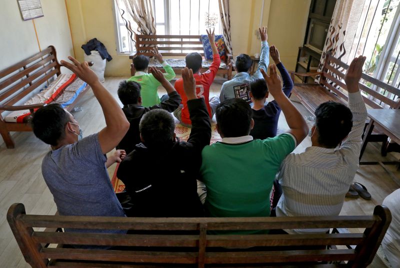 &copy; Reuters. FILE PHOTO: Myanmar nationals including those who said they are police and firemen and recently fled to India flash the three-finger salute at an undisclosed location in India's northeastern state of Mizoram, near the India-Myanmar border, March 15, 2021.