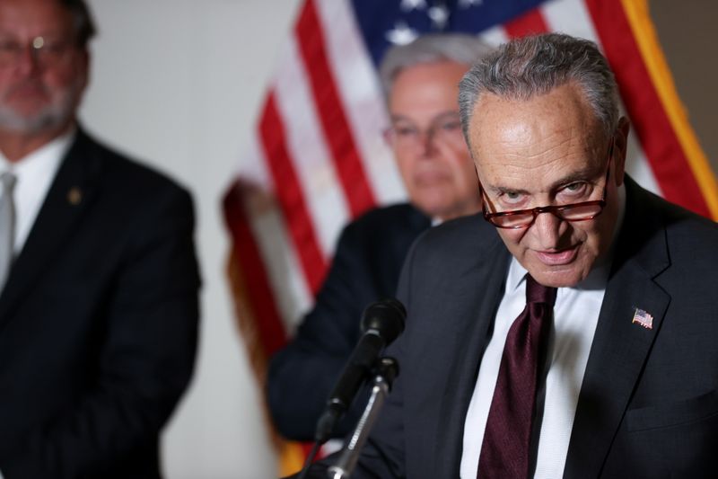 &copy; Reuters. U.S. Senate Majority Leader Chuck Schumer (D-NY), with Senator Gary Peters (D-MI) and Senator Bob Menendez (D-NJ), speaks to reporters during the weekly news conference following the Democratic caucus policy luncheon on Capitol Hill in Washington, U.S. Ma