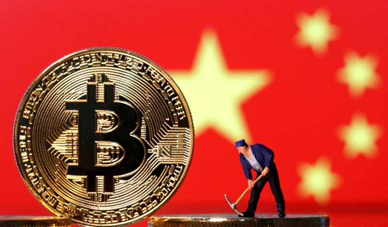 &copy; Reuters. FILE PHOTO: A small toy figurine is seen on representations of the Bitcoin virtual currency displayed in front of an image of China's flag in this illustration picture, April 9, 2019. REUTERS/Dado Ruvic/Illustration