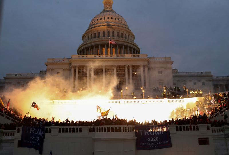 © Reuters. FILE PHOTO: An explosion caused by a police munition is seen while supporters of U.S. President Donald Trump gather in front of the U.S. Capitol Building in Washington, U.S., January 6, 2021. REUTERS/Leah Millis 
