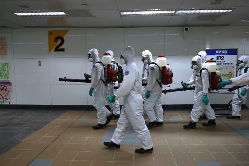 &copy; Reuters. Soldiers in protective suits disinfect a metro station following a surge of coronavirus disease (COVID-19) infections in Taipei, Taiwan May 20, 2021. REUTERS/Ann Wang
