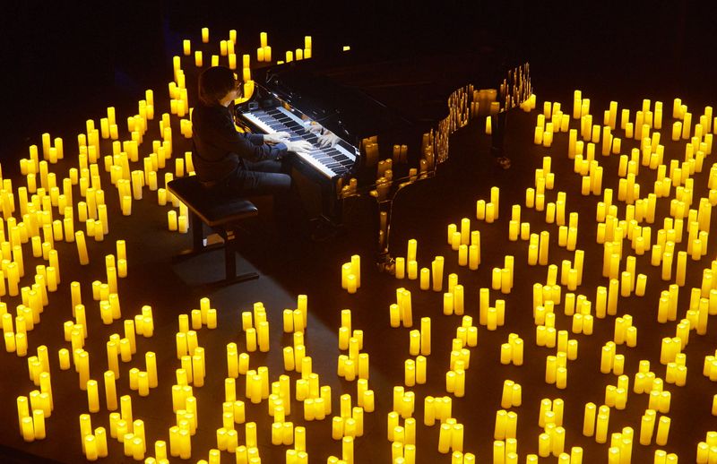 &copy; Reuters. French pianist Eric Artz performs Japanese animated theme songs illuminated with hundreds of candles as during easing of lockdown measures against the coronavirus disease (COVID-19) outbreak during the Candlelight series in Les Salons in Geneva, Switzerla