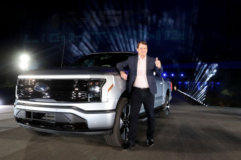 &copy; Reuters. Ford CEO Jim Farley poses with the all-electric Ford F-150 Lightning pickup truck during the unveiling at the company's world headquarters in Dearborn, Michigan, U.S., May 19, 2021. REUTERS/Rebecca Cook