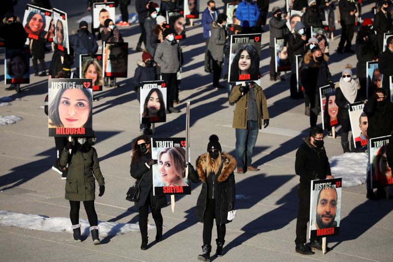 &copy; Reuters. FILE PHOTO: People hold placards with images of the victims of the downing of Ukraine International Airlines flight PS752, which was shot down near Tehran by Iran's Revolutionary Guards, as they gather to take part in a march to mark its first anniversary