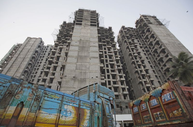 &copy; Reuters. FILE PHOTO: Trucks are parked at the site of an under-construction residential building project, which has been stalled, in Mumbai March 19, 2015. REUTERS/Danish Siddiqui