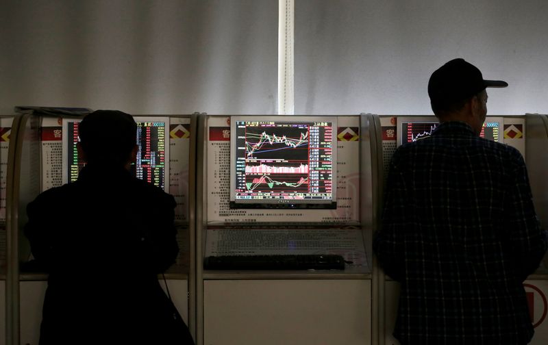 &copy; Reuters. FILE PHOTO: Investors check share prices at a brokerage office in Beijing, China January 2, 2020. REUTERS/Jason Lee