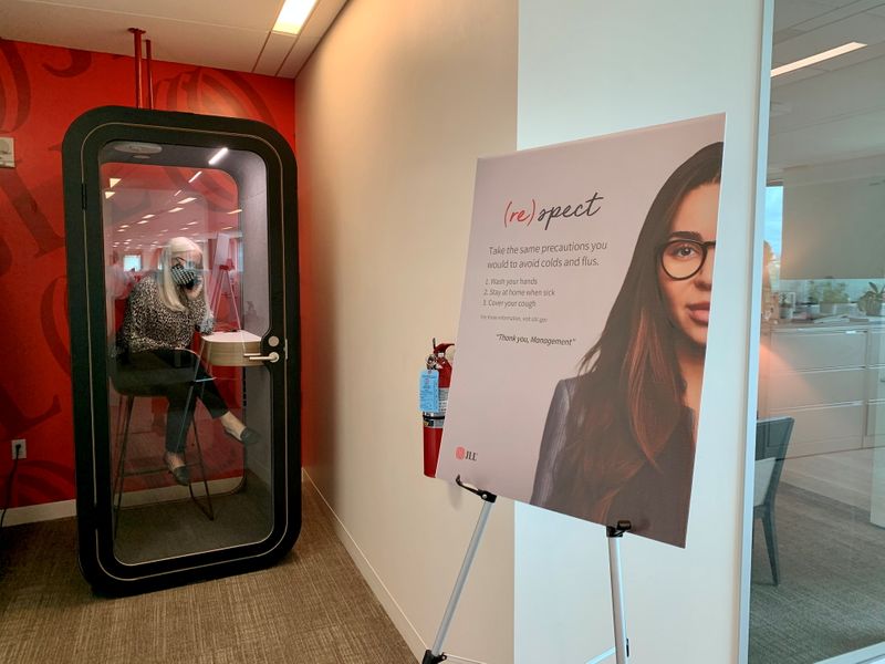 &copy; Reuters. FILE PHOTO: An employee makes a call in a newly-installed phone booth at real estate company JLL's Austin office in this undated handout photo. Hope Brusevold/JLL/Handout via REUTERS     