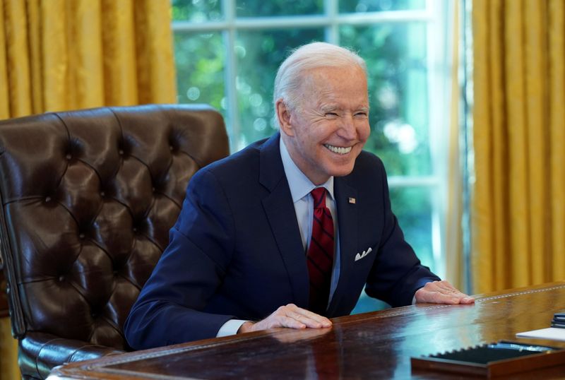&copy; Reuters. FILE PHOTO: U.S. President Joe Biden smiles after signing executive orders at the White House in Washington, U.S., January 28, 2021. REUTERS/Kevin Lamarque/File Photo