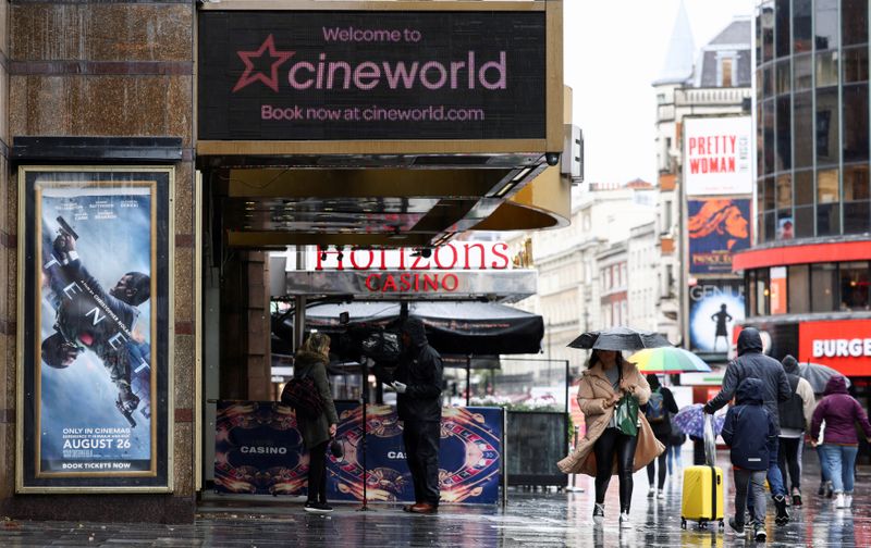 &copy; Reuters. FILE PHOTO: People walk past a Cineworld in Leicester's Square, amid the coronavirus disease (COVID-19) outbreak in London, Britain, October 4, 2020. REUTERS/Henry Nicholls