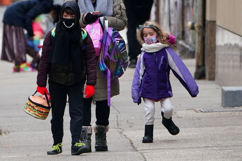 © Reuters. FILE PHOTO: A child skips to school at PS 361 on the first day of a return to class during the coronavirus disease (COVID-19) pandemic in the Manhattan borough of New York City, New York, U.S., December 7, 2020. REUTERS/Carlo Allegri