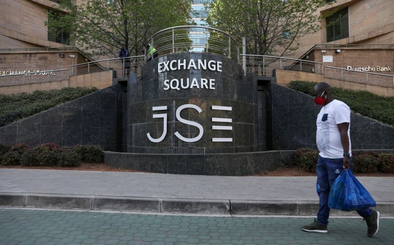 &copy; Reuters. FILE PHOTO: A man walks past the Johannesburg Stock Exchange (JSE), as the coronavirus disease (COVID-19) lockdown regulations are eased in Sandton, South Africa, September 10, 2020. REUTERS/Siphiwe Sibeko/File Photo