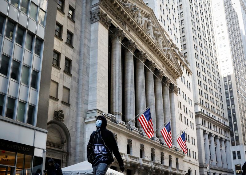 &copy; Reuters. FILE PHOTO: A man wears a mask as he walks near the New York Stock Exchange (NYSE) in the financial district in New York City, U.S., March 2, 2020. REUTERS/Brendan McDermid