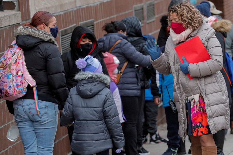 &copy; Reuters. FILE PHOTO: A principal greets students as they return to New York City's public schools for in-person learning, as the global outbreak of the coronavirus disease (COVID-19) continues, at P.S. 506 in Brooklyn, New York, U.S., December 7, 2020.  REUTERS/Br